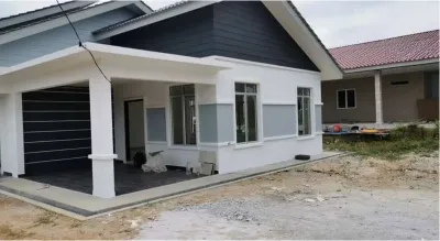 Completed single-storey bungalow built by RumahHQ — white walls with a grey band, dark grey boarding on the gable, a carport on white columns with dark floor tiles, and white-framed aluminium windows