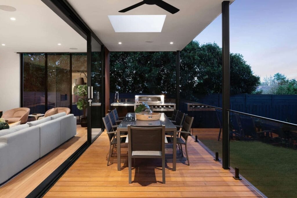 8 Sebab Yang Pemilik Tanah Malaysia Terlepas Pandang — Dan Cara Selesaikannya" 26 Modern patio dining area with outdoor kitchen, glass doors, and interior view of cozy living room.